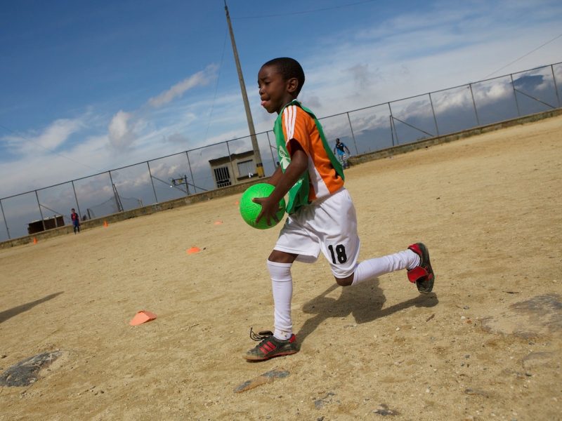 Children in the poor barrio of Bello Oriente, one of the highest located in the northeast of the city, participate in a soccer training organized by foundation Caminos and a local group.